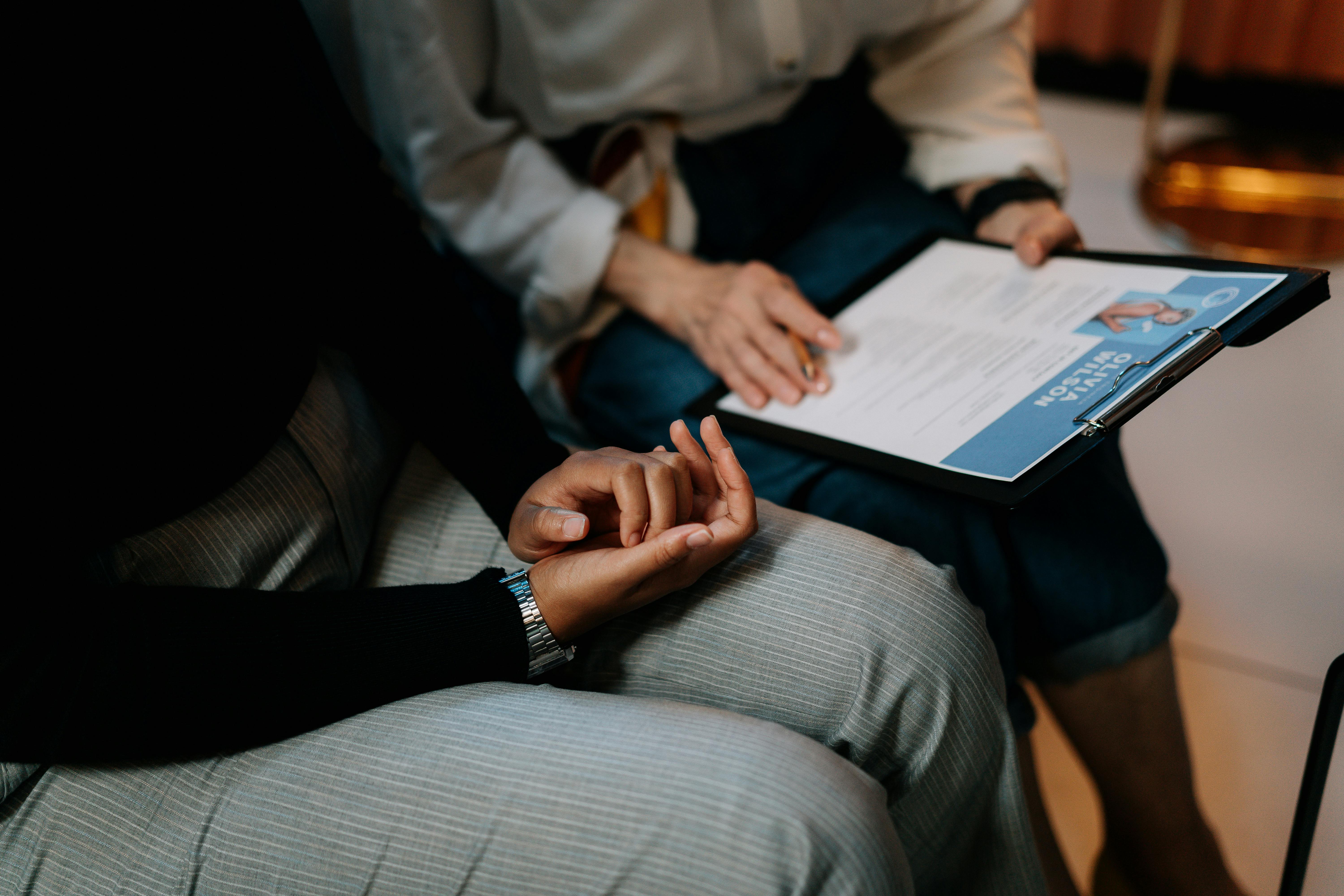  Two people reviewing a document in their laps.