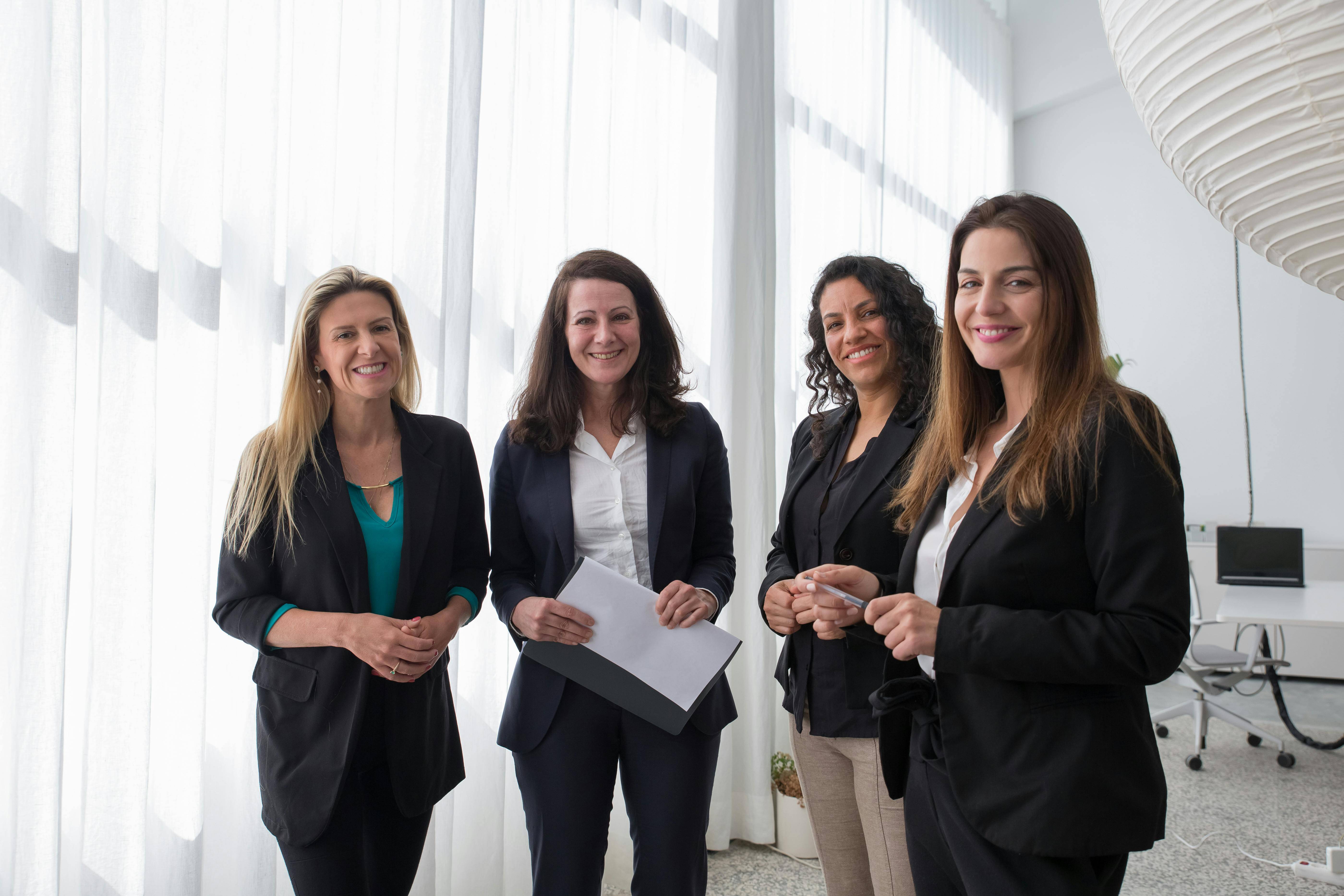 A group of women wearing suites