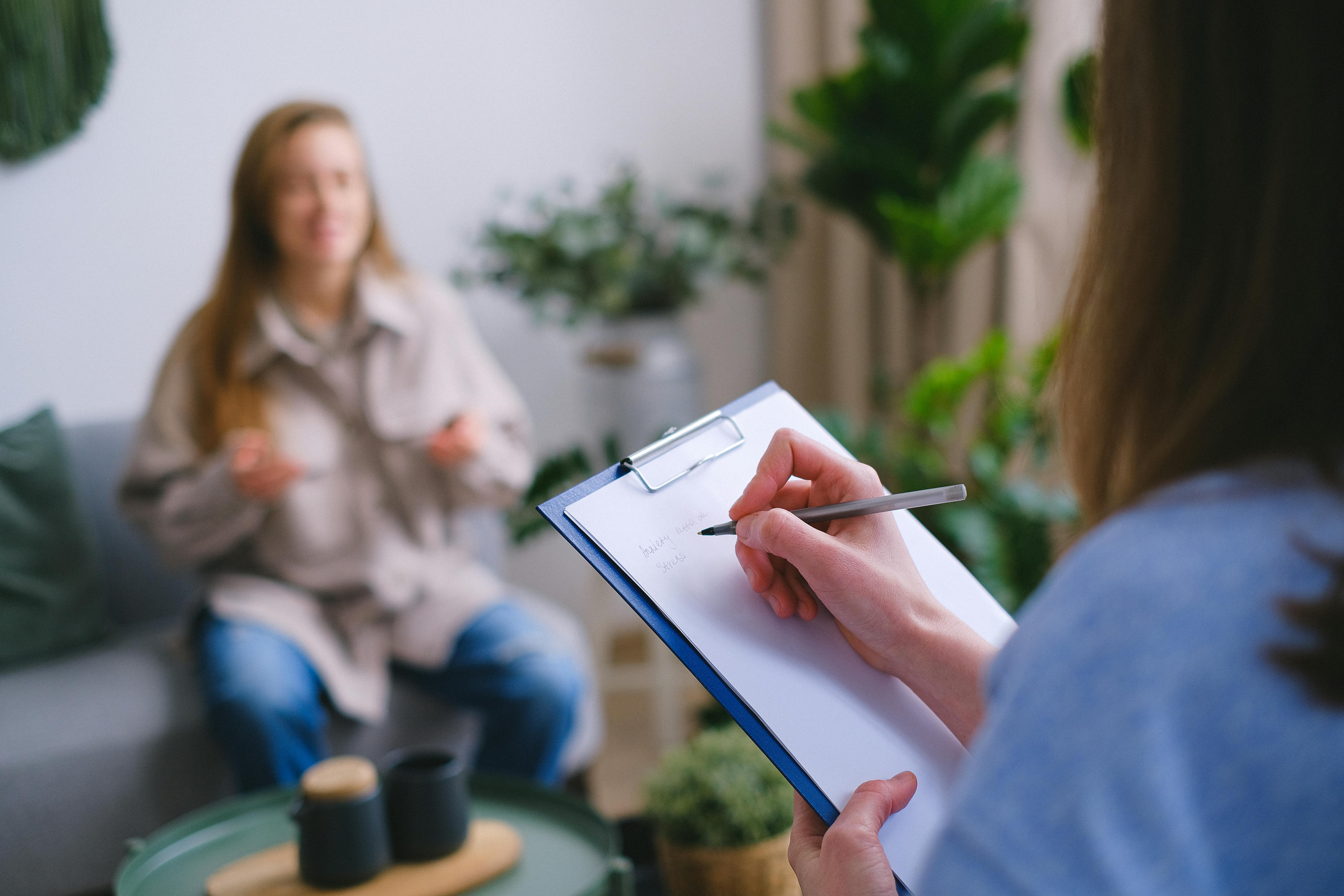 Woman with a clipboard taking questions from another woman