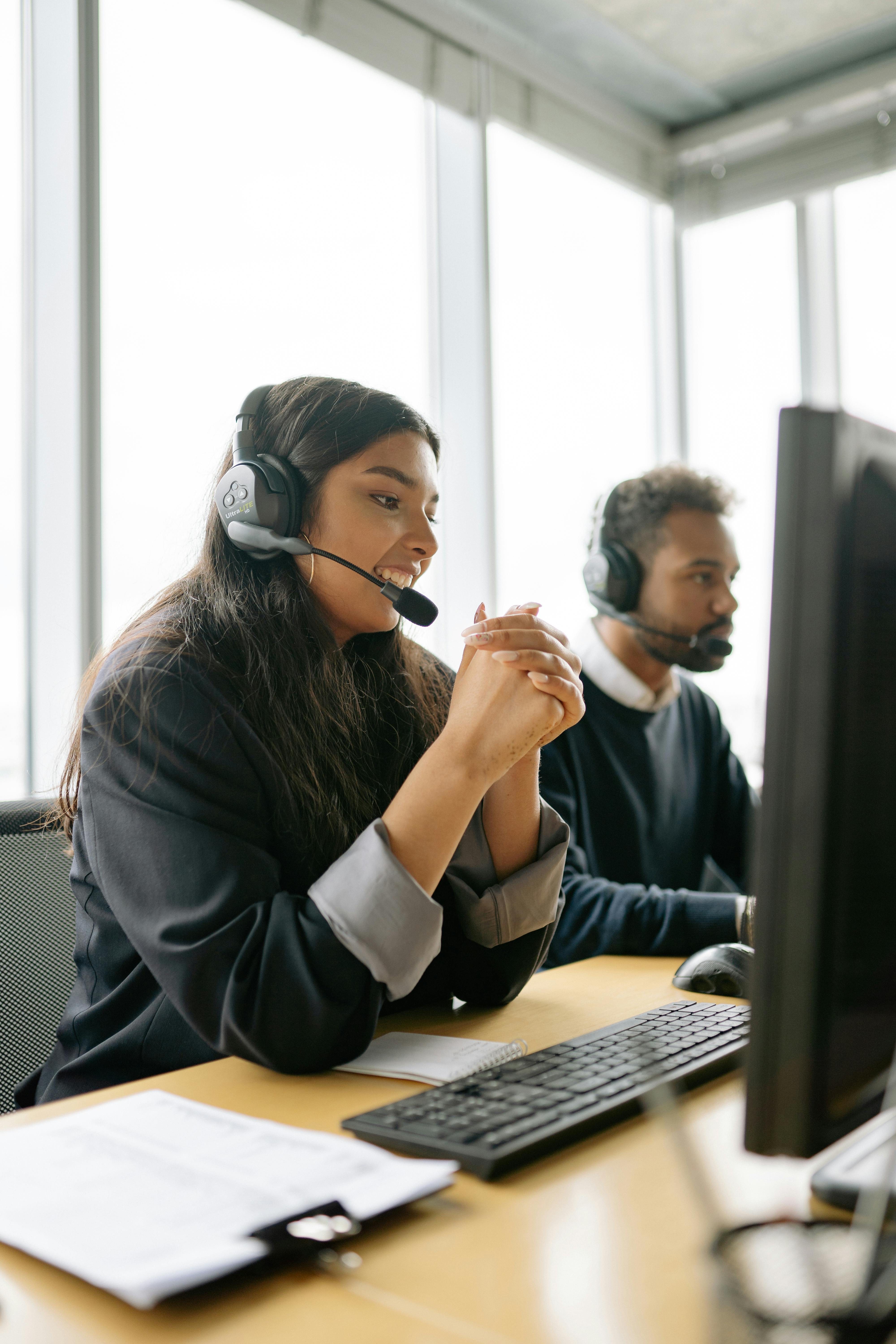 Woman at her desk answering a call on a headset